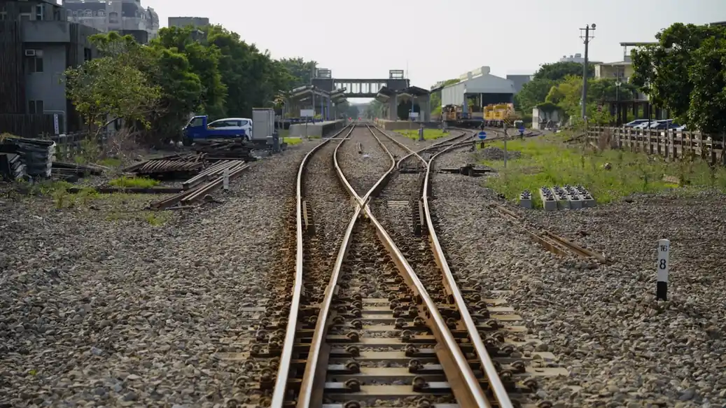 Un aiguillage où deux voies ferrées se croisent et se séparent, dans une gare de marchandises